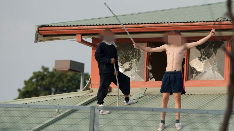 Youths protesting on the roof of the Melbourne Youth Justice Centre at Parkville in March last year.