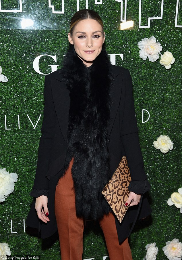 Style queen: Olivia Palermo, 30, cut a dash in burnt orange pants paired with a black coat with fake fur trim and long fluffy scarf in NYC on Tuesday night