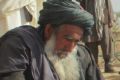 Afghan villagers gather around the bodies of people killed during clashes between Taliban and Afghan security forces in ...