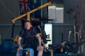 Photo of Andy Harrison at his shed which he converted to a gym.