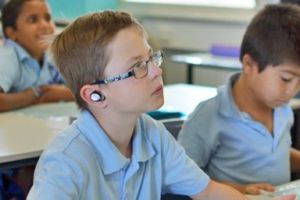 Perth school boy Kai finds it easier to concentrate on the teacher's voice with Nuheara's IQbuds helping to compensate ...