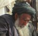 Afghan villagers gather around the bodies of people killed during clashes between Taliban and Afghan security forces in ...