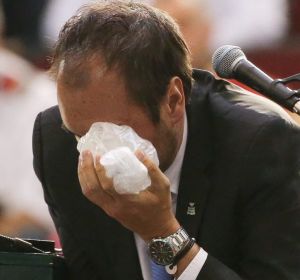 Chair umpire Arnaud Gabas reacts to getting hit in the eye with a ball.