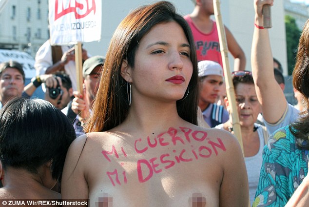  Some of the protesters had their chests painted with slogans, including this woman whose message reads 'my body, my choice' in Spanish