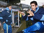 OLDHAM, UNITED KINGDOM - FEBRUARY 08:  Leeds United forward Eric Cantona calms the media down as he looks on from the bench prior to making his Leeds debut as a substitute during the League Division One match between Oldham Athletic and Leeds United at Boundary Park on February 8, 1992 in Oldham, England.  (Photo by Stephen Munday/Allsport/Getty Images)