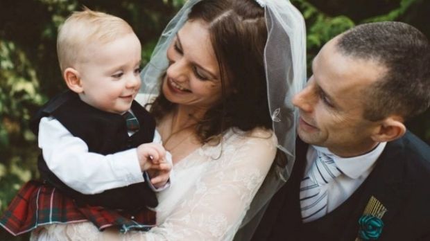 The couple with their son Charlie who looked "cute as a button" on their wedding day.