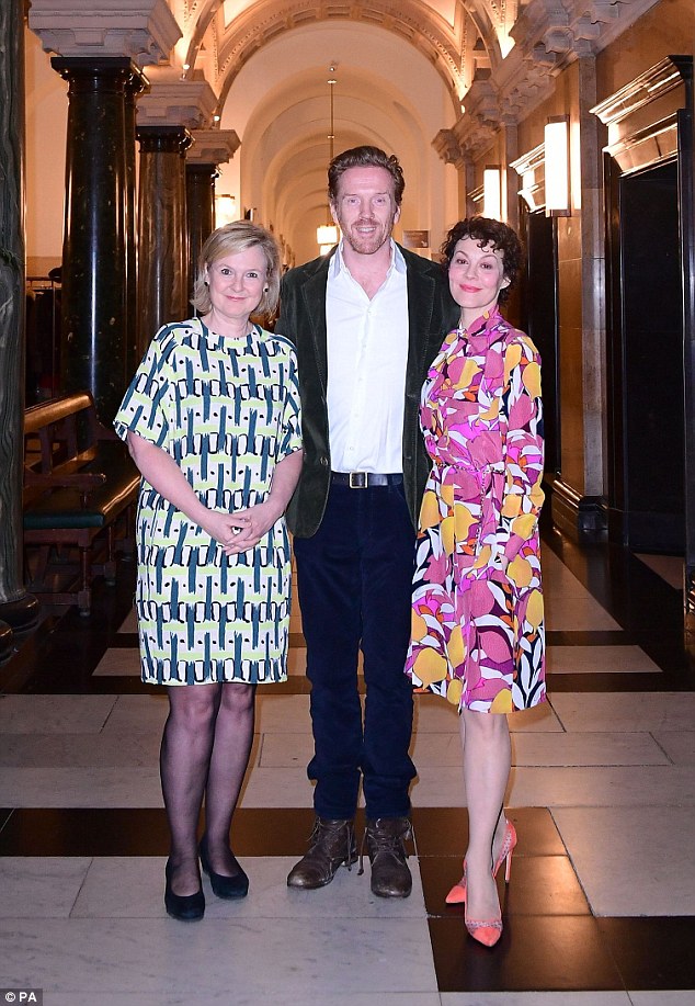 Terrific trio: Damian, 45, also smartened up for the occasion, lacing an arm around his wife's waist as the pair posed with event host, broadcaster Martha