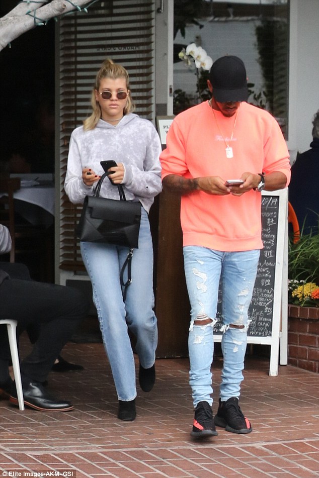 Hanging out: The Select Model Management talent wore cool, round sunglasses with a pastel purple, acid-washed hooded sweatshirt and she enjoyed the afternoon with a friend