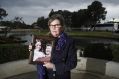 Margaret Dodd, pictured with a photo of her daughter Hayley Dodd and her father Raymond.