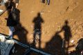 Palestinians inspect the wreckage of a chicken farm in hit by an Israeli air strike on Shujaya, Gaza.