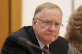 Senator Ian Macdonald listens to response from Solicitor-General Justin Gleeson SC during a public hearing before the ...