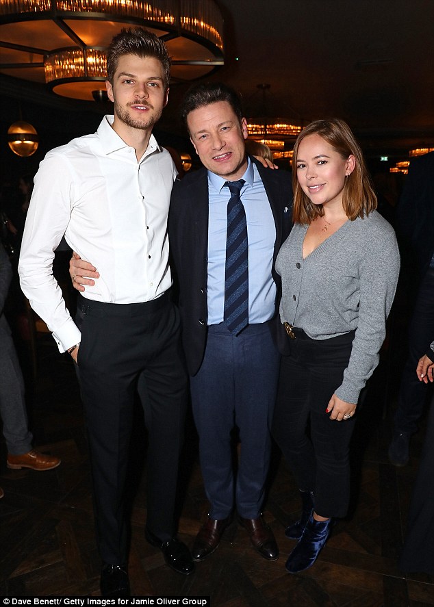 Man in the middle: Jamie sought out blogger Tanya Burr and her husband Jim Chapman for a snap