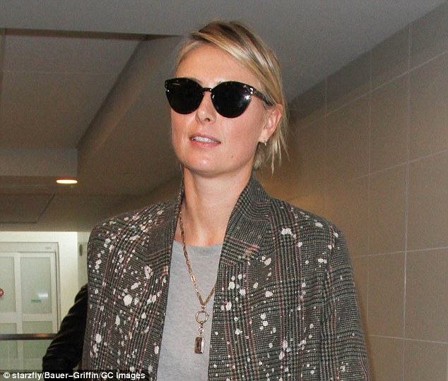 Fresh-faced: Maria scraped her newly touched-up flaxen locks into a bun and wore black cat-eye sunglasses over her make-up free complexion