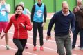 Kate Middleton lets Prince William beat her during a race for a London Marathon training day in London on Sunday.