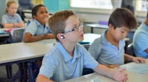 Perth school boy Kai finds it easier to concentrate on the teacher's voice with Nuheara's IQbuds helping to compensate ...