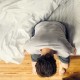 A man sitting on the edge of his bed.