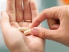 closeup female hands with two pills