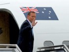 Prime Minister Tony Abbott waves as he leaves Fairbairn RAAF base in Canberra on April 5, 2014. 