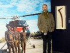 NMA consultant curator Dr John Carty with the wirlki boomerang and a photo by John Veevers.