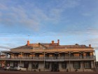 The sun is setting on a grand old Australian pub