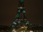 The Eiffel Tower in Paris, France, lit up with green lights for the World Climate Change Conference.