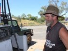 A picture of a man filling his car tank with diesel fuel