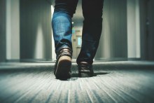 Man walking down office corridor (Pexels)