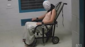 A teenage Dylan Voller has a hood placed over his head and is strapped to a chair at the Don Dale Detention Centre in the NT.