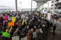 Hundreds of demonstrators gather during a protest at Detroit Metropolitan Airport.
