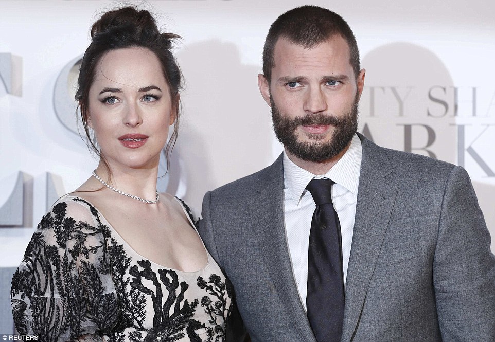 On-screen lovers: The Northern Irish hunk posed alongside Dakota, who plays his on-screen love interest Anastasia Steele