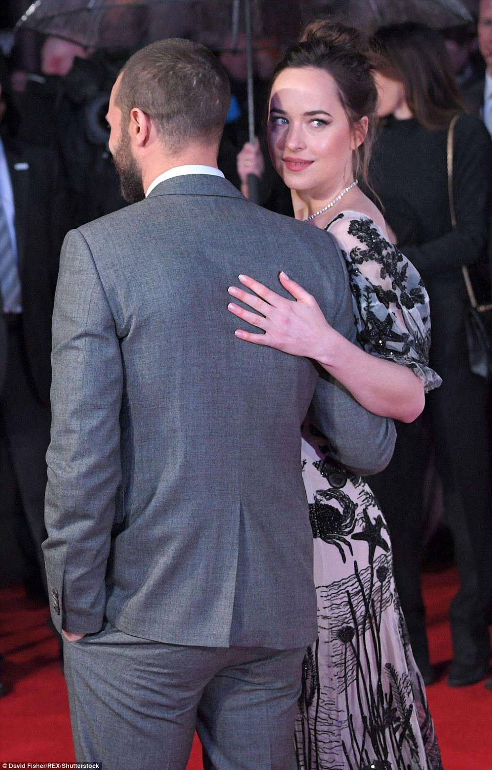 Arm-in-arm: Dakota and Jamie posed like professionals for the wall of photographers in Leicester Square 