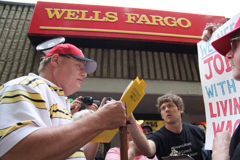 David Goodner coordinates a leadership team of rank and file workers and everyday people during a "Fight For A Fair Economy: Make Wall Street Pay" action outside of Wells Fargo in Iowa City. / Photo courtesy of Iowa Citizens for Community Improvement.