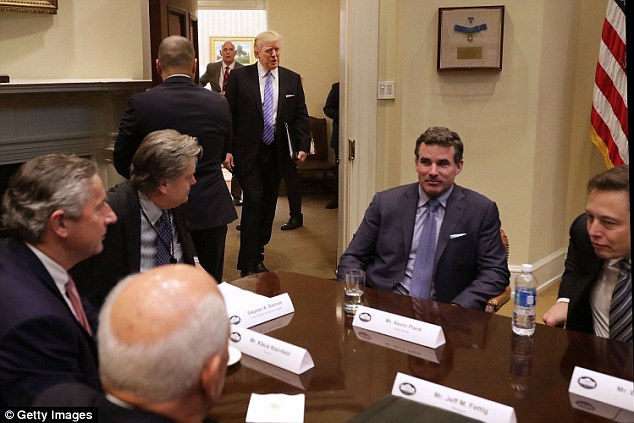 Trump is seen above walking into the Roosevelt Room for a meeting with Plank (second from right), SpaceX CEO Elon Musk (far right), and other business leaders on January 23 at the White House. Top aide Steve Bannon is seen sitting third from left