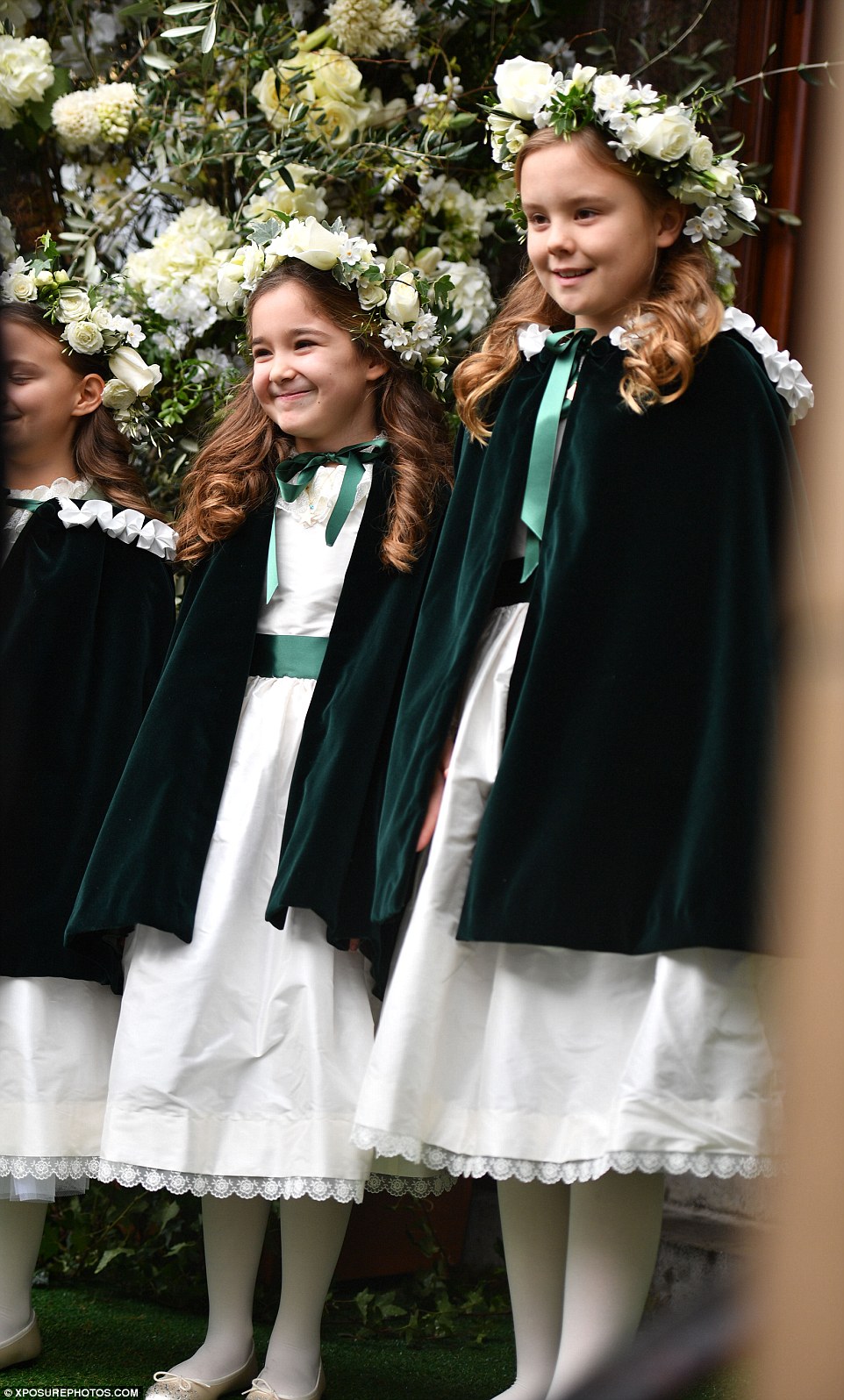 Ready for duty: The cute flower girls grinned for the camera before walking the bride down the aisle 