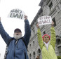 David Pearce, left, and his daughter Crissy Pearce hold signs outside of the 9th U.S. Circuit Court of Appeals in San Francisco, Tuesday, Feb. 7, 2017. President Donald Trump's travel ban faced its biggest legal test yet Tuesday as a panel of federal judges prepared to hear arguments from the administration and its opponents about two fundamentally divergent views of the executive branch and the court system. (AP Photo/Jeff Chiu)