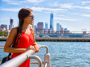 Young woman enjoying a boat roat ride looking out into the ocean.