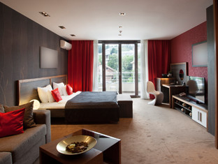 A brown and red sophisticated hotel room.