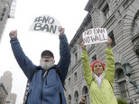 David Pearce, left, and his daughter Crissy Pearce hold signs outside of the 9th U.S. Circuit Court of Appeals in San Francisco, Tuesday, Feb. 7, 2017. President Donald Trump's travel ban faced its biggest legal test yet Tuesday as a panel of federal judges prepared to hear arguments from the administration and its opponents about two fundamentally divergent views of the executive branch and the court system. (AP Photo/Jeff Chiu)