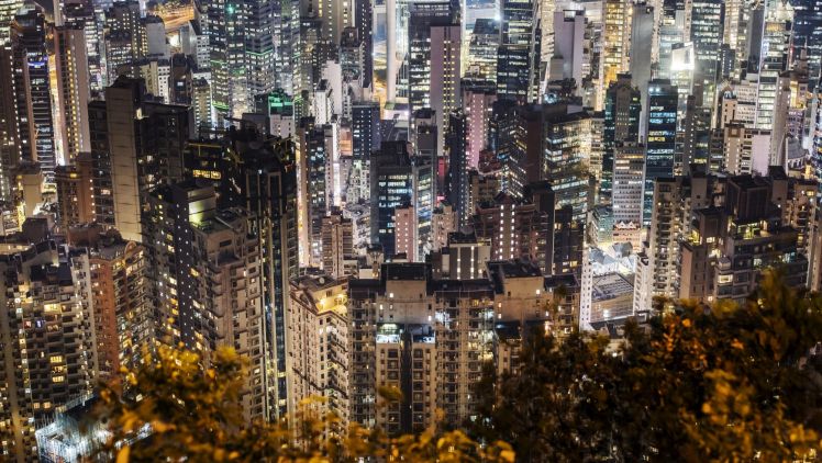 Residential and commercial buildings stand illuminated at night in Hong Kong. New home sales soared 48 per cent in January.