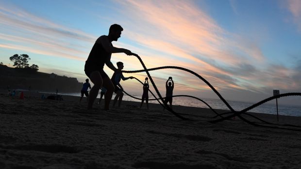 People exercise at Coogee before the weather heats up.