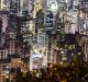 Residential and commercial buildings stand illuminated at night in Hong Kong. New home sales soared 48 per cent in January.