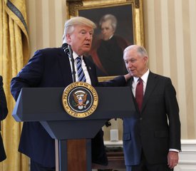 President Donald Trump talks to Attorney General Jeff Sessions in the Oval Office of the White House in Washington, Thursday, Feb. 9, 2017, before Vice President Mike Pence administered the oath of office Sessions.