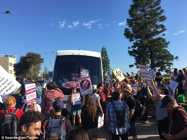 More than 100 protesters surround a bus taking Q Society members to a fundraising dinner