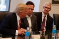 Apple CEO Tim Cook, right, and PayPal founder Peter Thiel, centre, listen as Donald Trump speaks during a meeting with ...