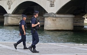 French Police officers patrol along the Seine river in Paris, France, Friday, Sept. 2, 2016.