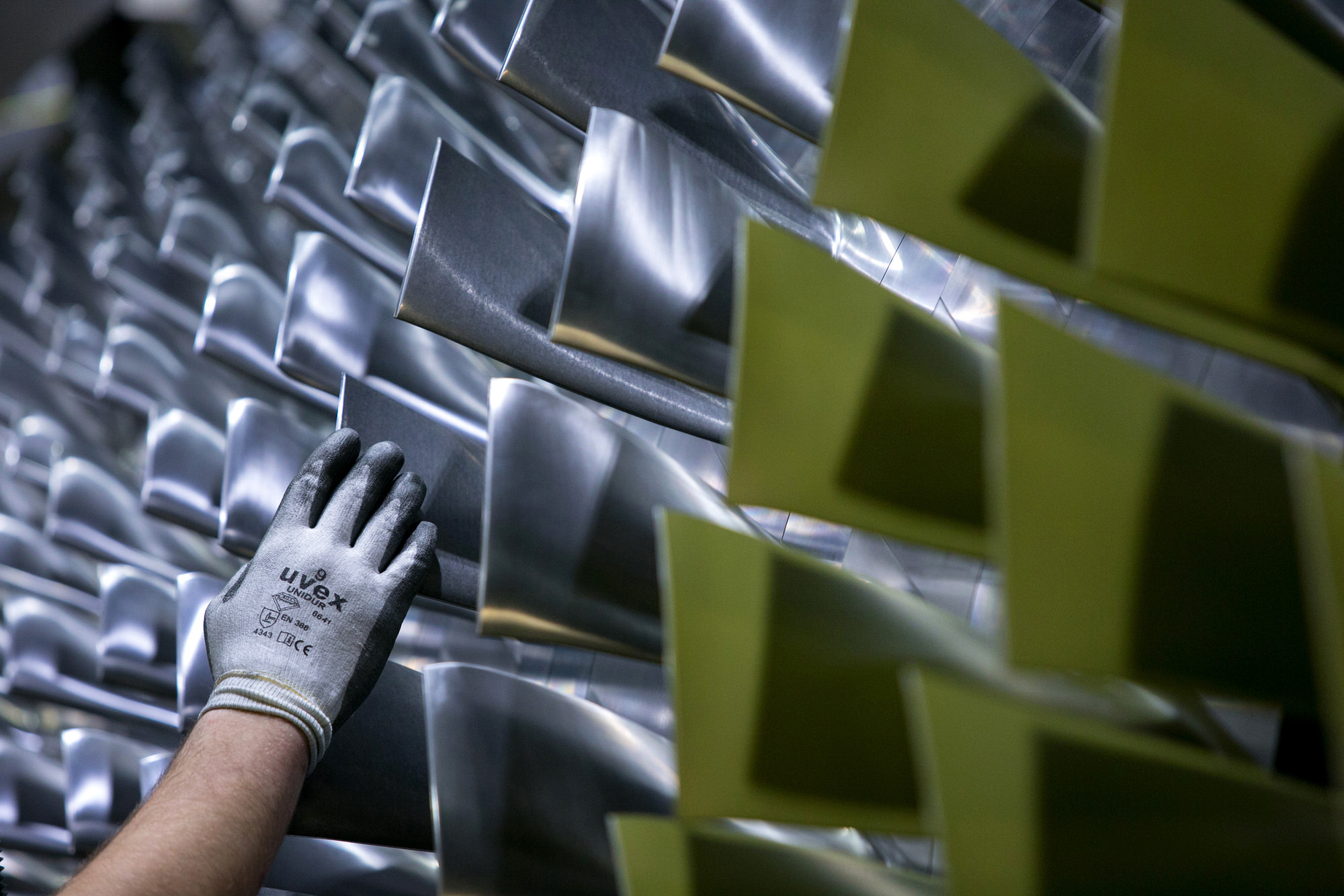 An employee inspects the blades on a H-class turbine on the assembly line of Siemens AG's gas turbine factory in Berlin, Germany, on Tuesday, Feb. 2, 2016. Siemens, Europe's largest engineering company, criticized the U.K. government for creating uncertainty in the energy industry, saying it hampers investment in gas plants, wind farms and factories. Photographer: Krisztian Bocsi/Bloomberg