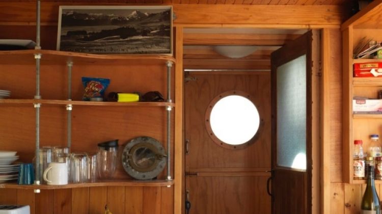 Mementoes including Chris’ father’s black and white picture of Aoraki (Mount Cook), which Chris climbed last year, and an old porthole sit on the kitchen shelf.