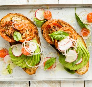 Avocado toast with roast tomatatoes and herb salad. 