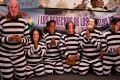 People wearing masks of Peruvian politicians pretend to be prisoners during a protest calling for justice after the ...