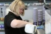 Trainee pours milk at the coffee machine.